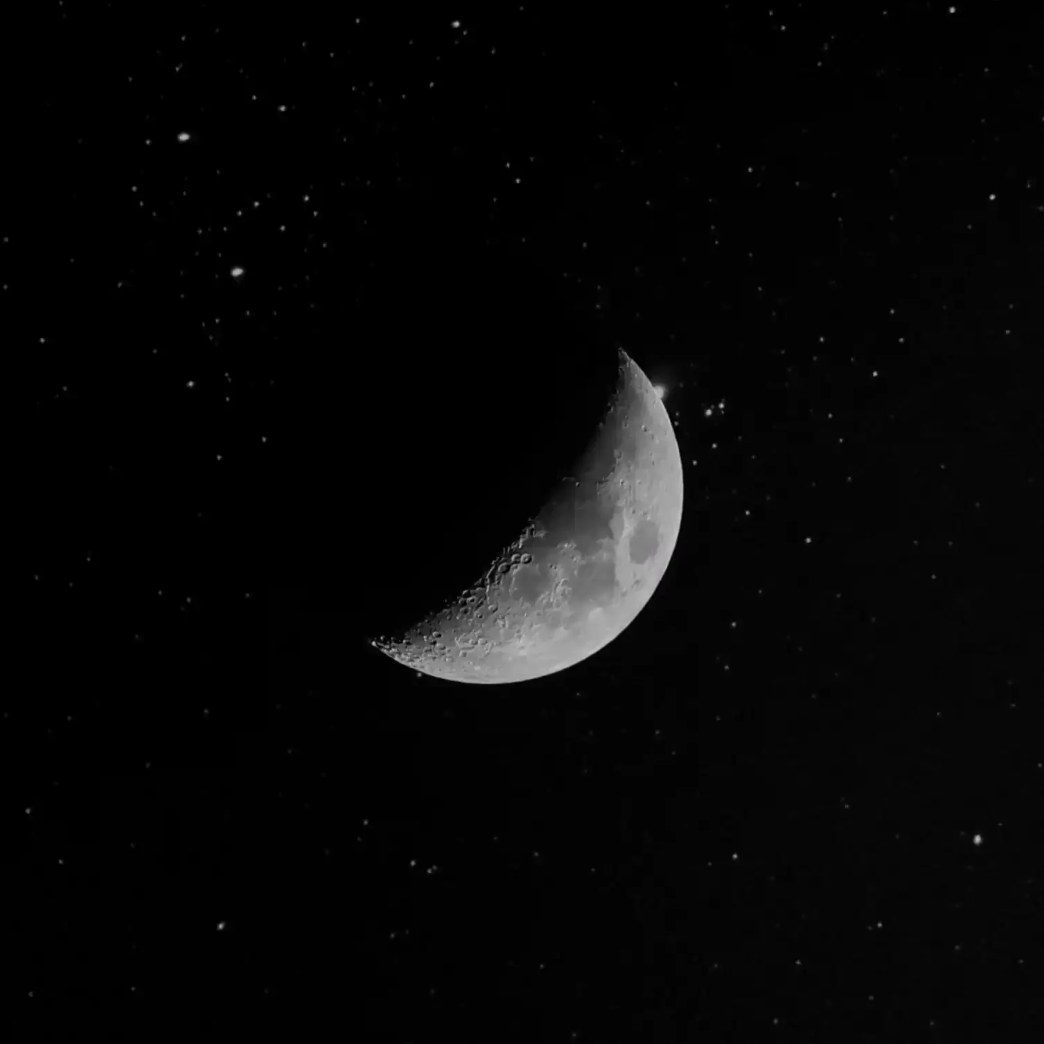 A crescent moon in a starry night sky