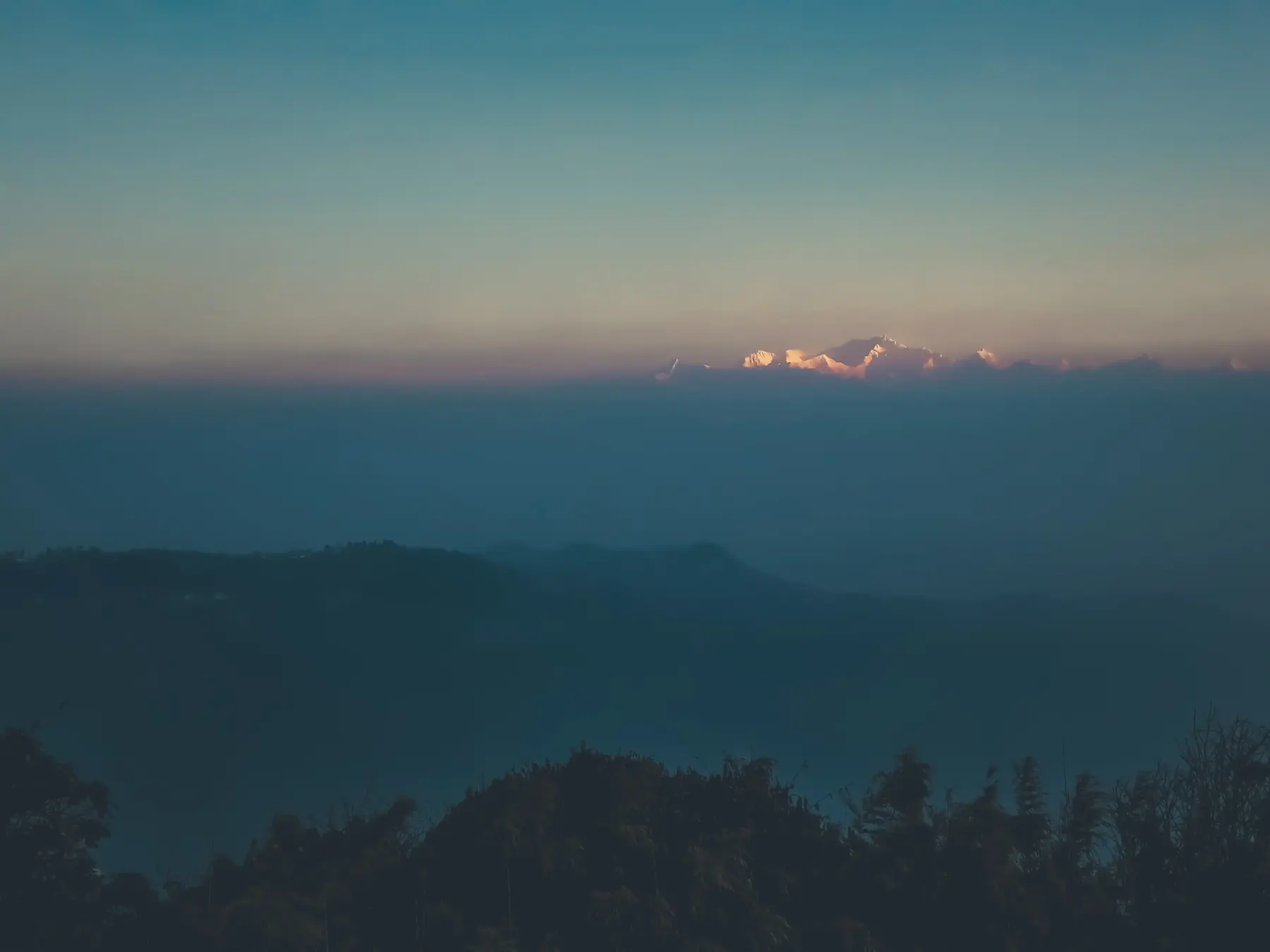 Layered mountain ranges fading into blue haze