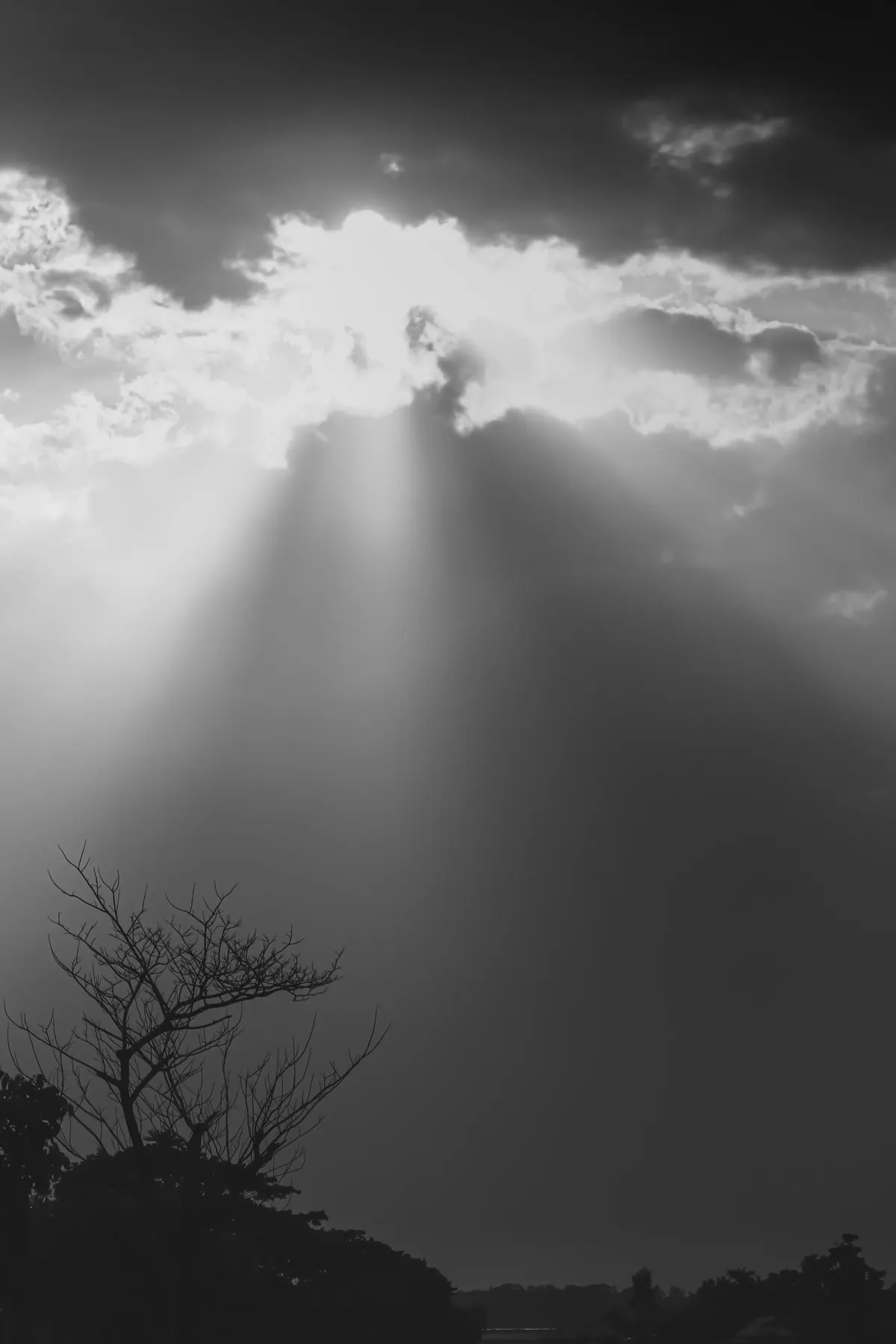 Black and white sunbeams breaking through storm clouds