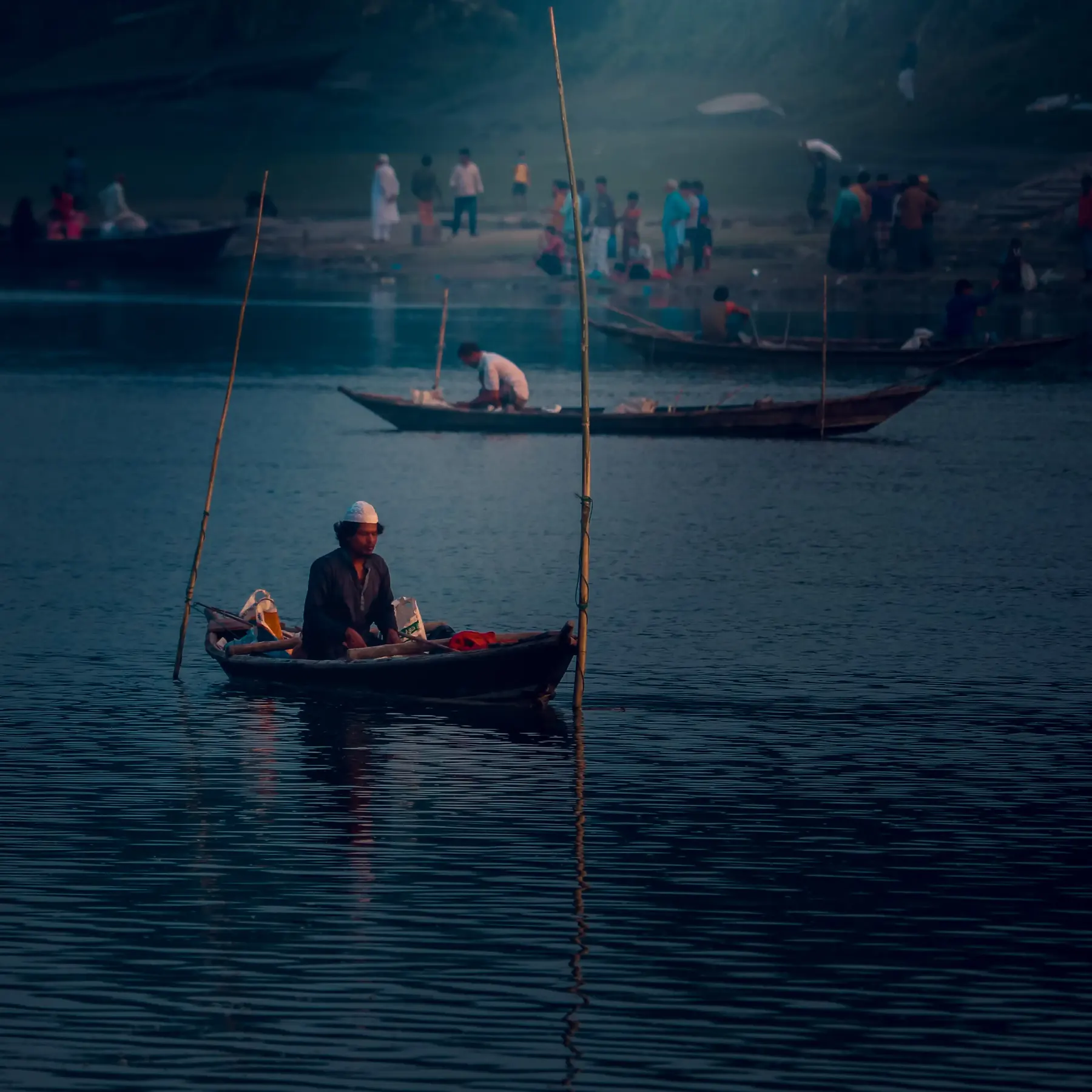 Boats and people on a river in the morning haze