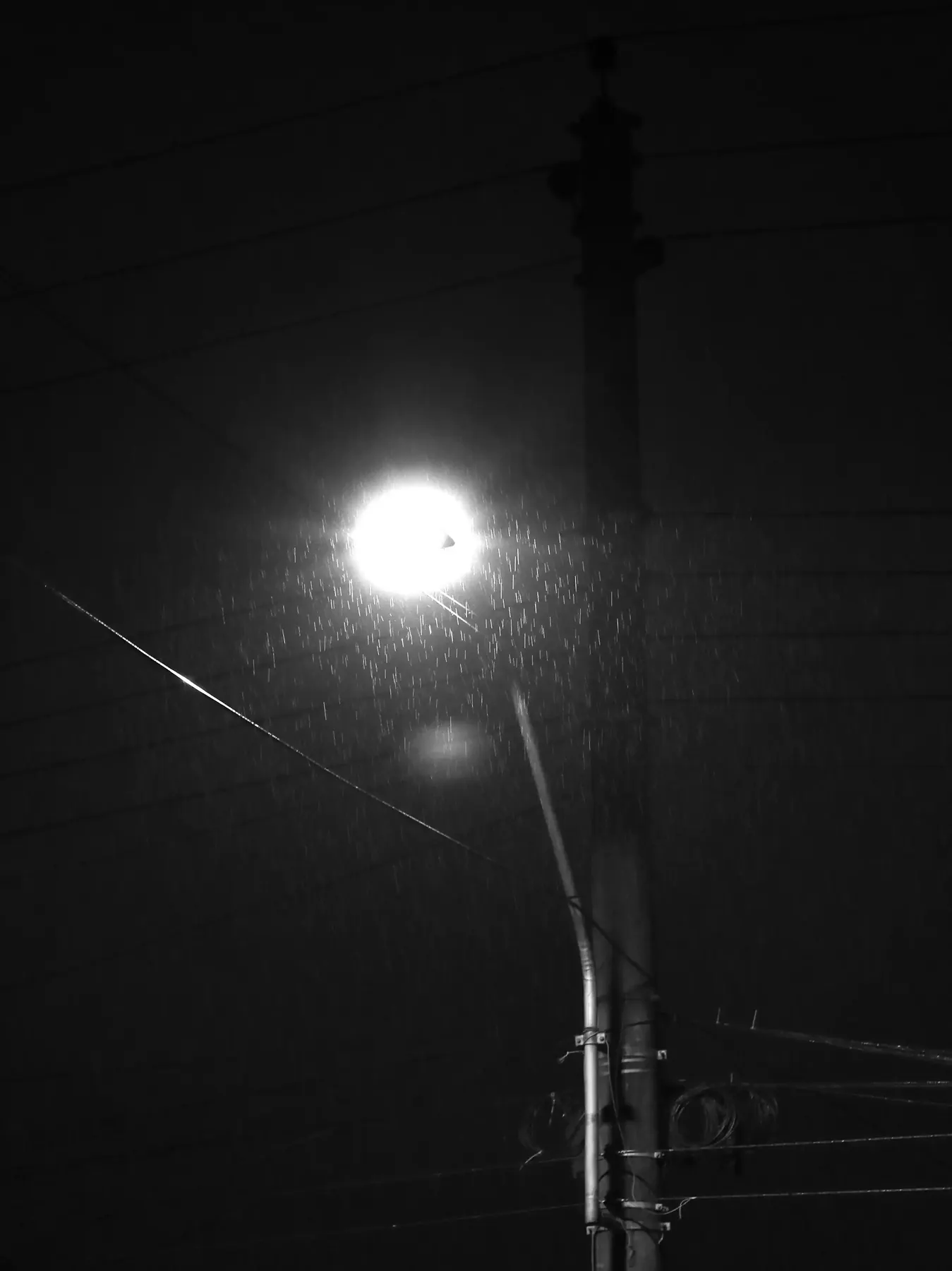A streetlight glowing in foggy night air